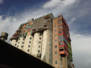 Illustration for article titled This Shipping Container City Above an Old Grain Silo Is Actually a Dorm
